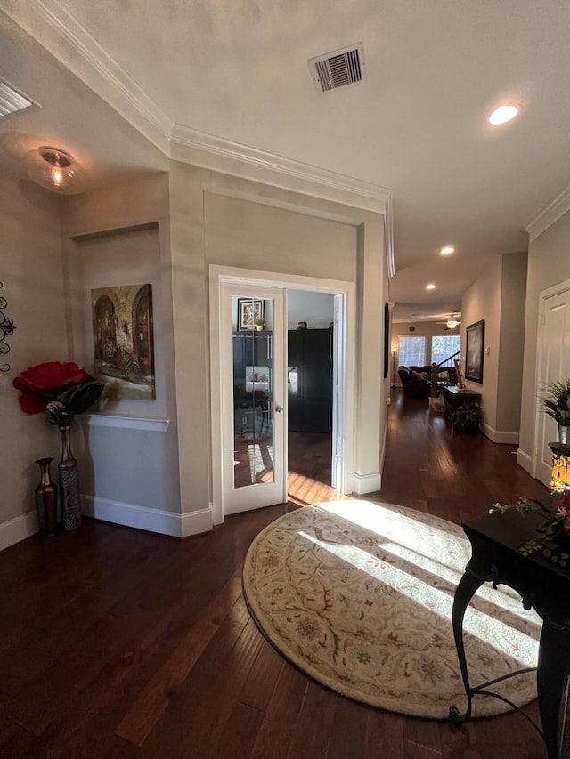 corridor with french doors, visible vents, crown molding, and hardwood / wood-style flooring