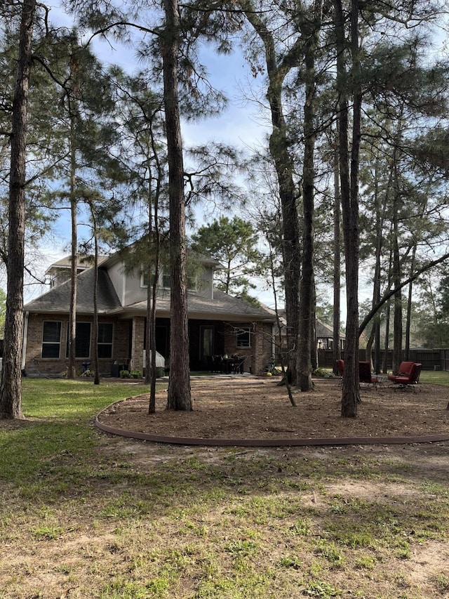 exterior space with brick siding and a lawn