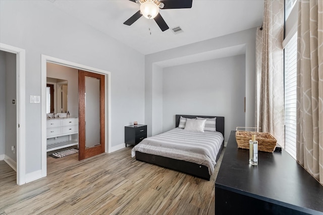 bedroom with visible vents, a sink, light wood-style floors, baseboards, and ceiling fan