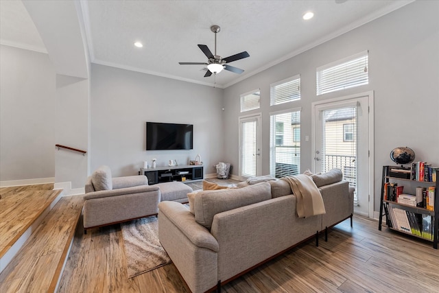 living area featuring recessed lighting, ornamental molding, baseboards, and wood finished floors