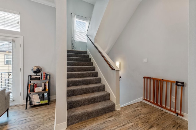 stairs with wood finished floors and baseboards