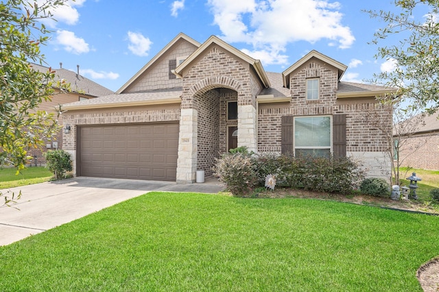 french country home with driveway, an attached garage, a front lawn, and brick siding