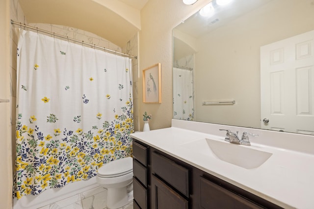 bathroom featuring marble finish floor, shower / tub combo, vanity, and toilet