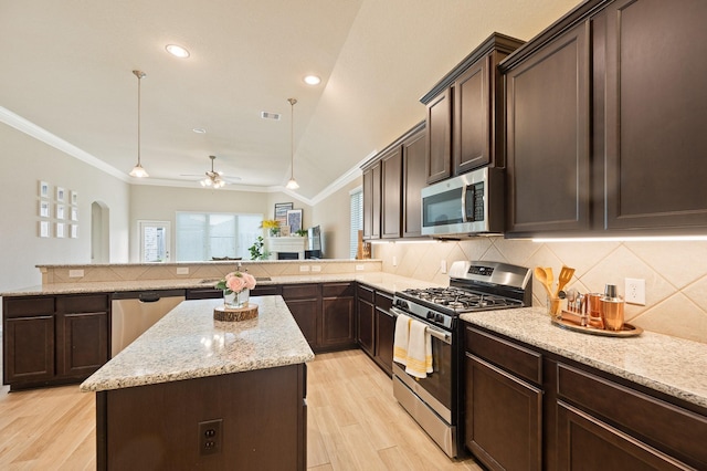 kitchen featuring tasteful backsplash, stainless steel appliances, crown molding, and a center island