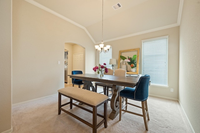 dining room with ornamental molding, visible vents, arched walkways, and light colored carpet