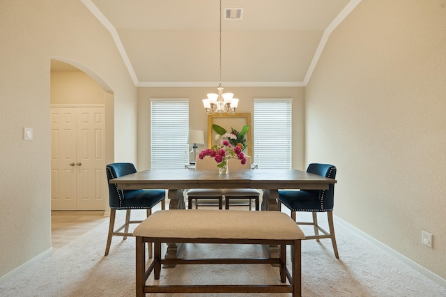 dining room featuring lofted ceiling, light colored carpet, crown molding, and visible vents