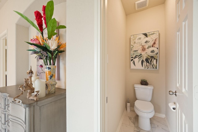 bathroom with toilet, marble finish floor, baseboards, and visible vents