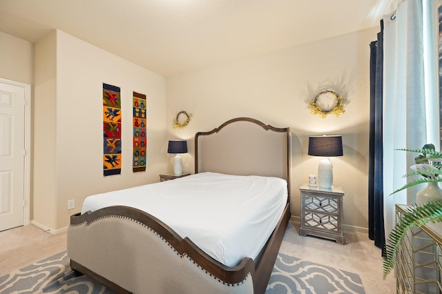 carpeted bedroom featuring baseboards