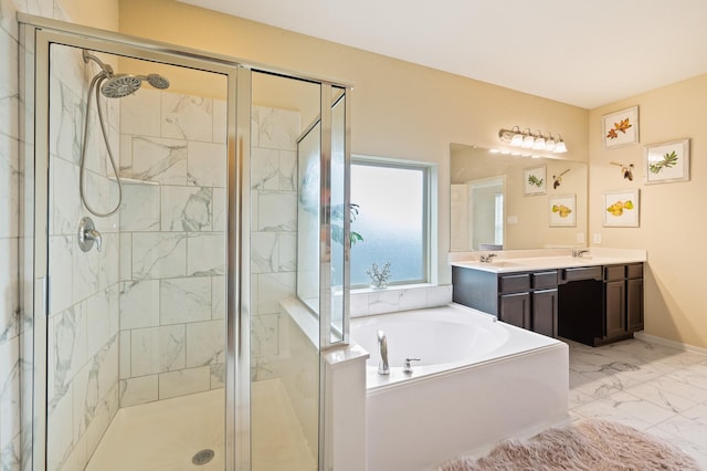 bathroom featuring marble finish floor, a garden tub, double vanity, a sink, and a shower stall