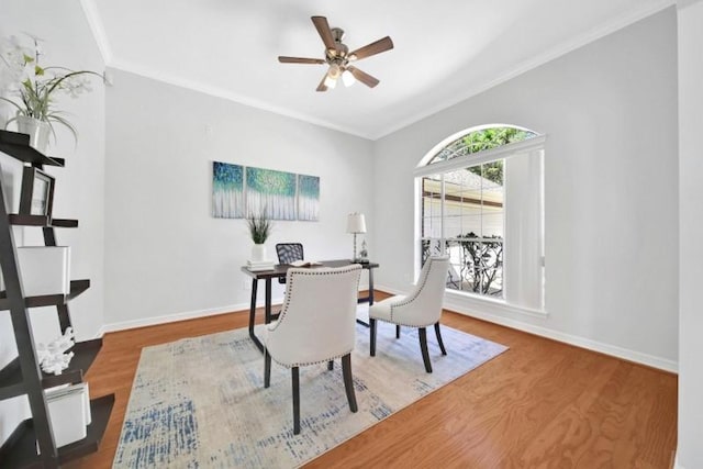 home office with baseboards, wood finished floors, a ceiling fan, and crown molding