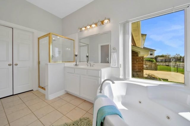 bathroom with a shower stall, vanity, a tub with jets, and tile patterned floors