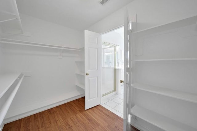 spacious closet with visible vents and wood finished floors