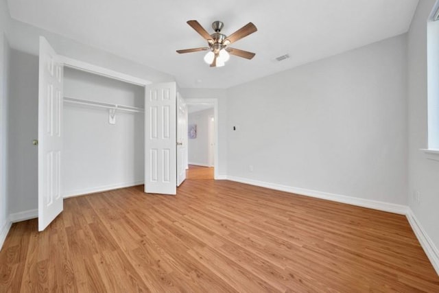 unfurnished bedroom with visible vents, baseboards, a ceiling fan, light wood-style flooring, and a closet