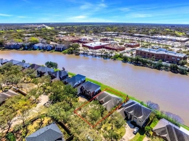 drone / aerial view with a residential view and a water view