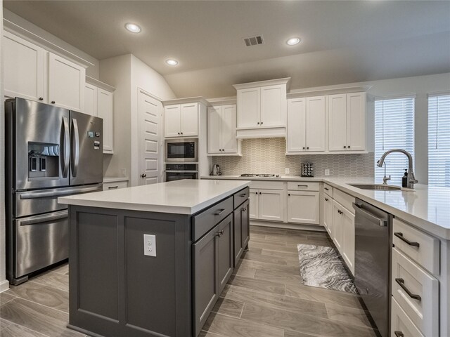 kitchen with visible vents, white cabinets, appliances with stainless steel finishes, and a sink