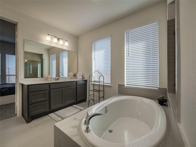 bathroom featuring vanity, a garden tub, and tile patterned flooring