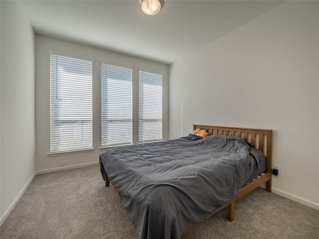 bedroom featuring baseboards and carpet floors