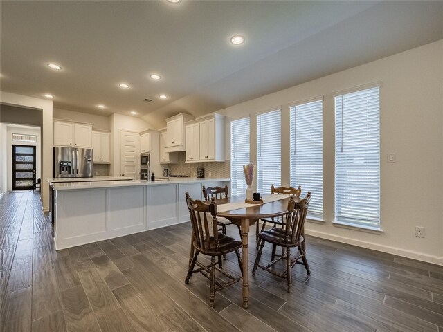 dining room with recessed lighting, baseboards, and dark wood-style flooring