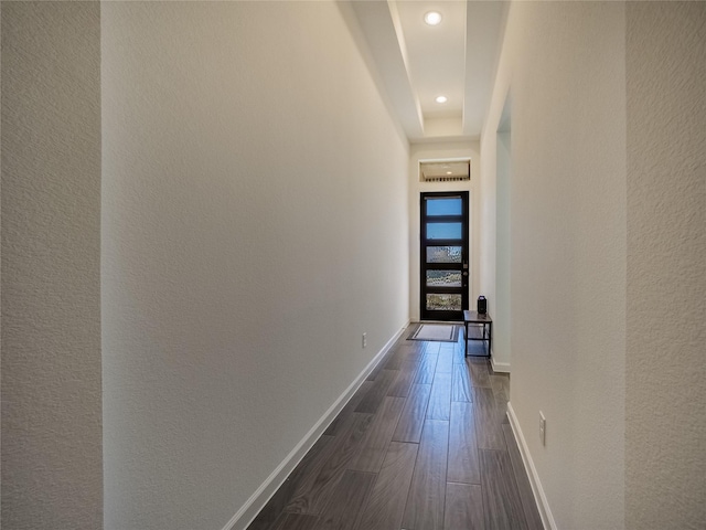 corridor featuring dark wood-style floors, recessed lighting, and baseboards