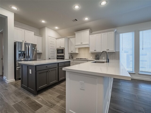 kitchen with visible vents, gray cabinetry, a sink, stainless steel appliances, and white cabinets