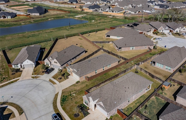 drone / aerial view with a residential view and a water view