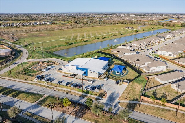 drone / aerial view with a residential view and a water view