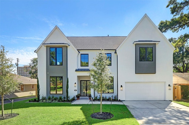 modern farmhouse style home featuring a garage, concrete driveway, a front yard, and stucco siding