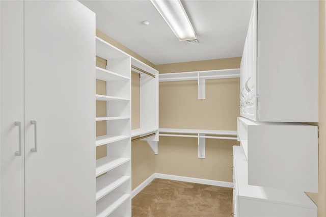 spacious closet featuring light carpet and visible vents