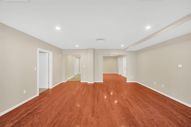 empty room featuring recessed lighting, light wood-style flooring, and baseboards