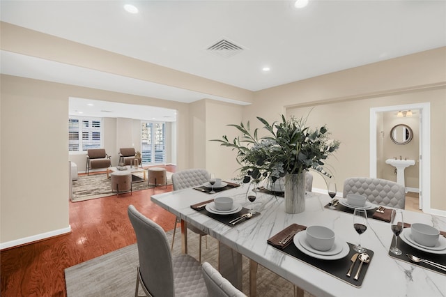 dining room featuring visible vents, recessed lighting, baseboards, and wood finished floors