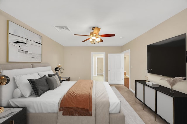 bedroom with light carpet, visible vents, baseboards, and ceiling fan