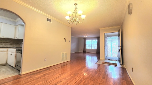 interior space featuring white cabinets, visible vents, and stainless steel dishwasher