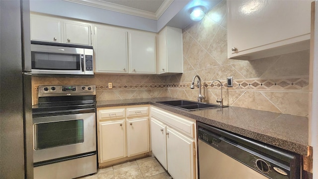 kitchen with stainless steel appliances, dark countertops, backsplash, ornamental molding, and a sink