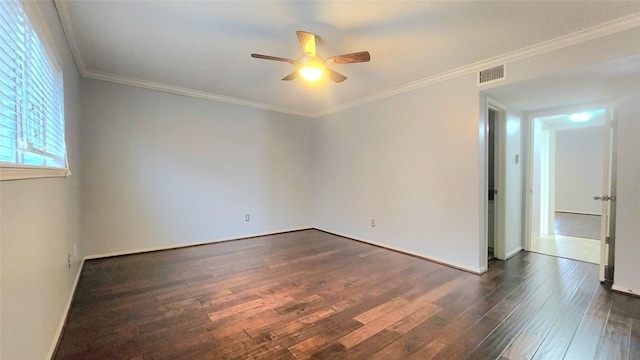 unfurnished room with dark wood-style floors, visible vents, ornamental molding, and a ceiling fan