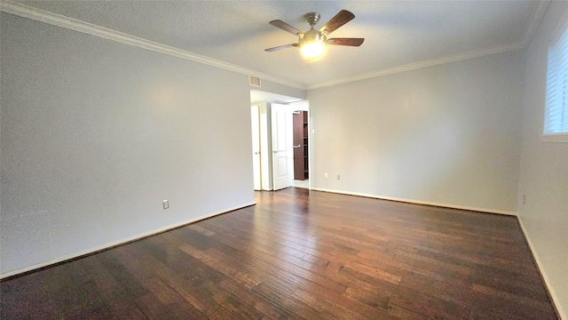 spare room featuring dark wood-style floors, visible vents, ornamental molding, ceiling fan, and baseboards