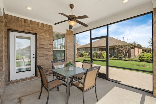 sunroom featuring ceiling fan