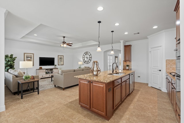 kitchen with a sink, brown cabinets, visible vents, and stainless steel appliances