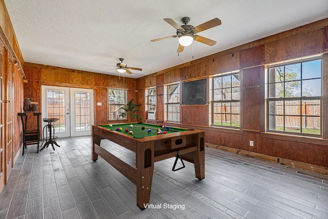 rec room with a wealth of natural light, wood walls, and billiards