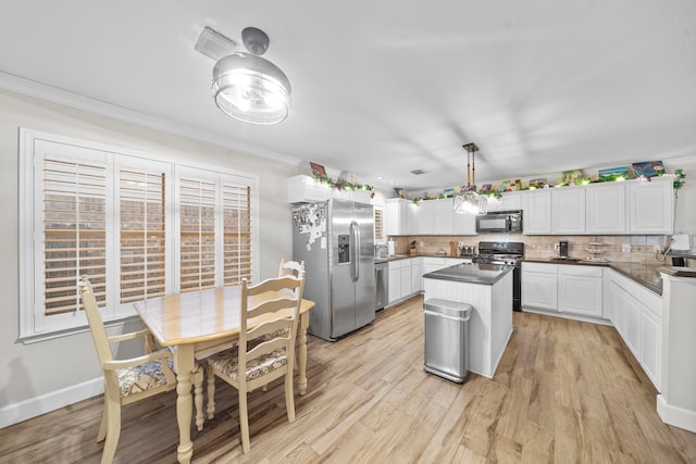 kitchen featuring black appliances, tasteful backsplash, dark countertops, and white cabinets