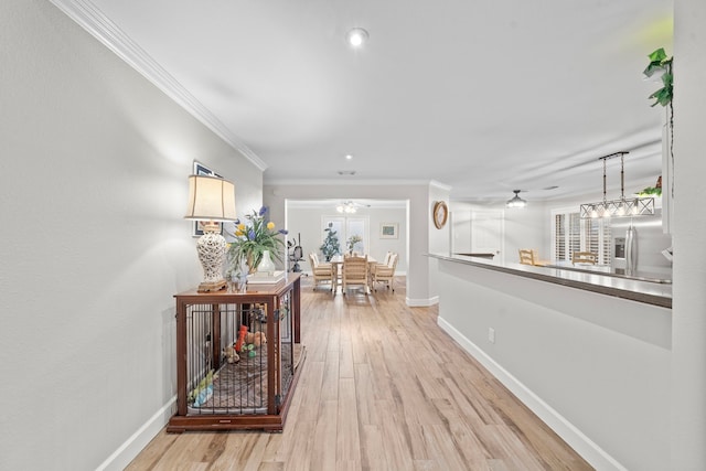 corridor with light wood-style floors, recessed lighting, crown molding, and baseboards