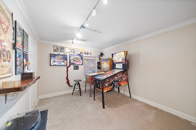 carpeted office featuring rail lighting, baseboards, and crown molding