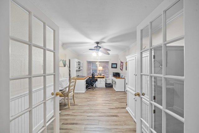 office area featuring a ceiling fan, french doors, crown molding, and light wood finished floors