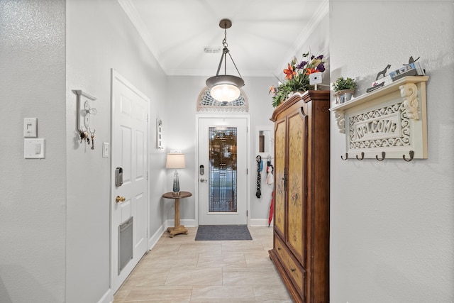 entrance foyer with ornamental molding, visible vents, and baseboards