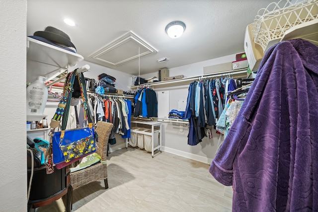 walk in closet with visible vents and attic access