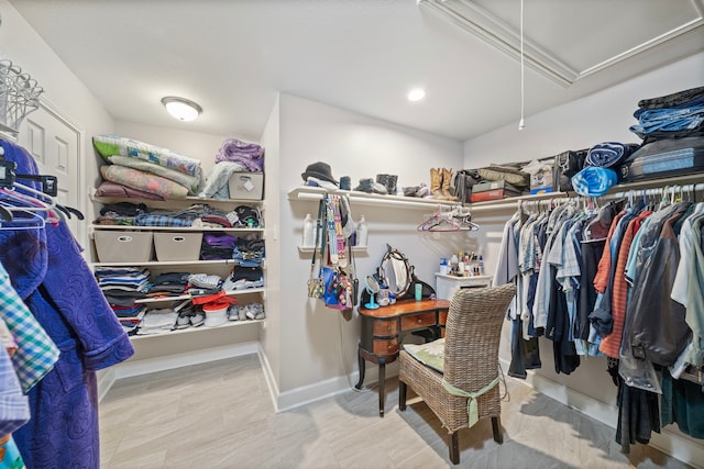 walk in closet featuring attic access