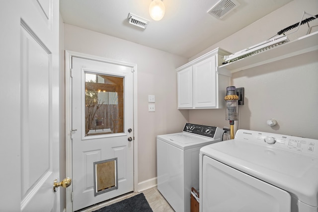 laundry area with washer and dryer, cabinet space, visible vents, and baseboards