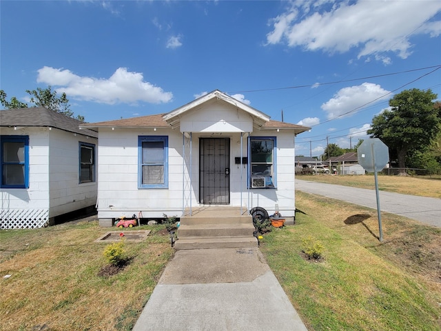 bungalow-style home with a front lawn