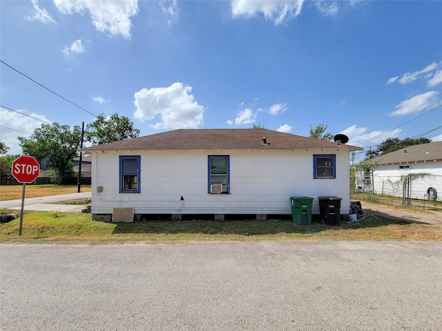 view of side of home featuring fence