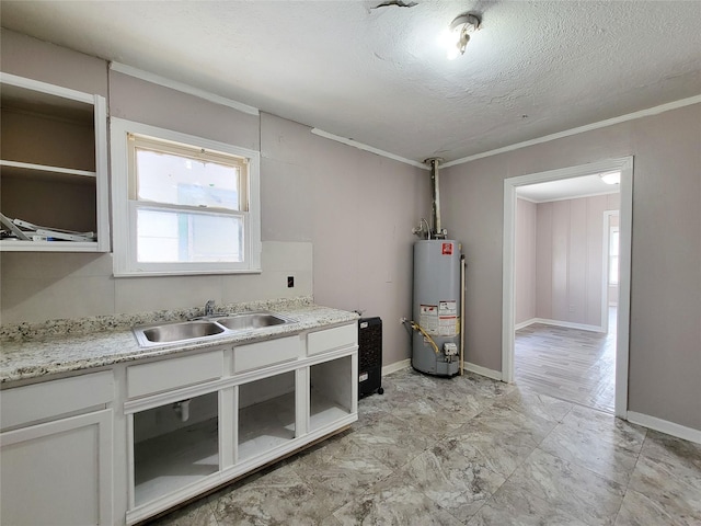 interior space with a textured ceiling, a sink, baseboards, water heater, and ornamental molding