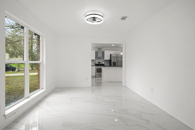 interior space with marble finish floor, baseboards, and visible vents